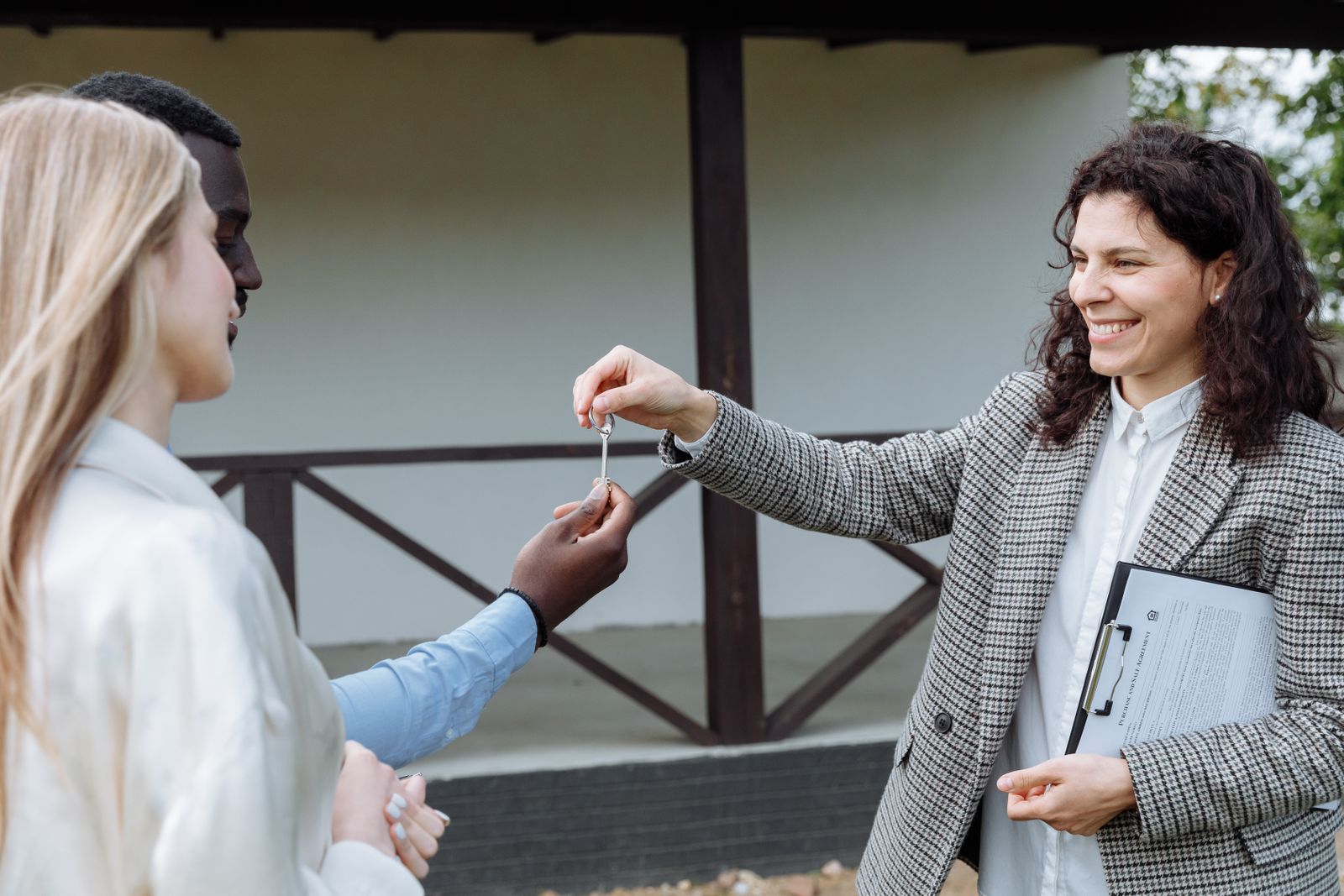 A housing coordinator handing keys to arriving guests